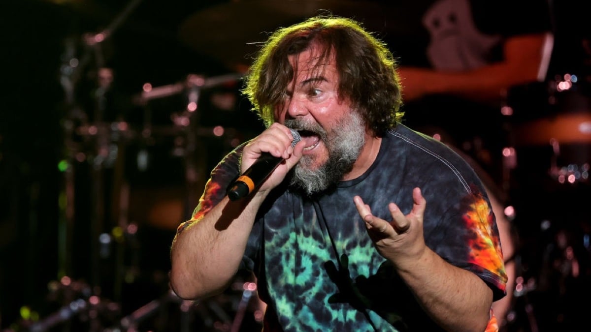 Jack Black shouting into a microphone emphatically.