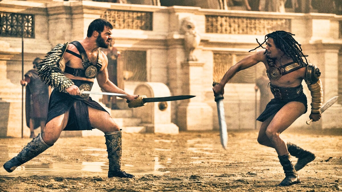 two gladiators duke it out using swords in an arena